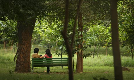 Toyboy flirting with older woman in park